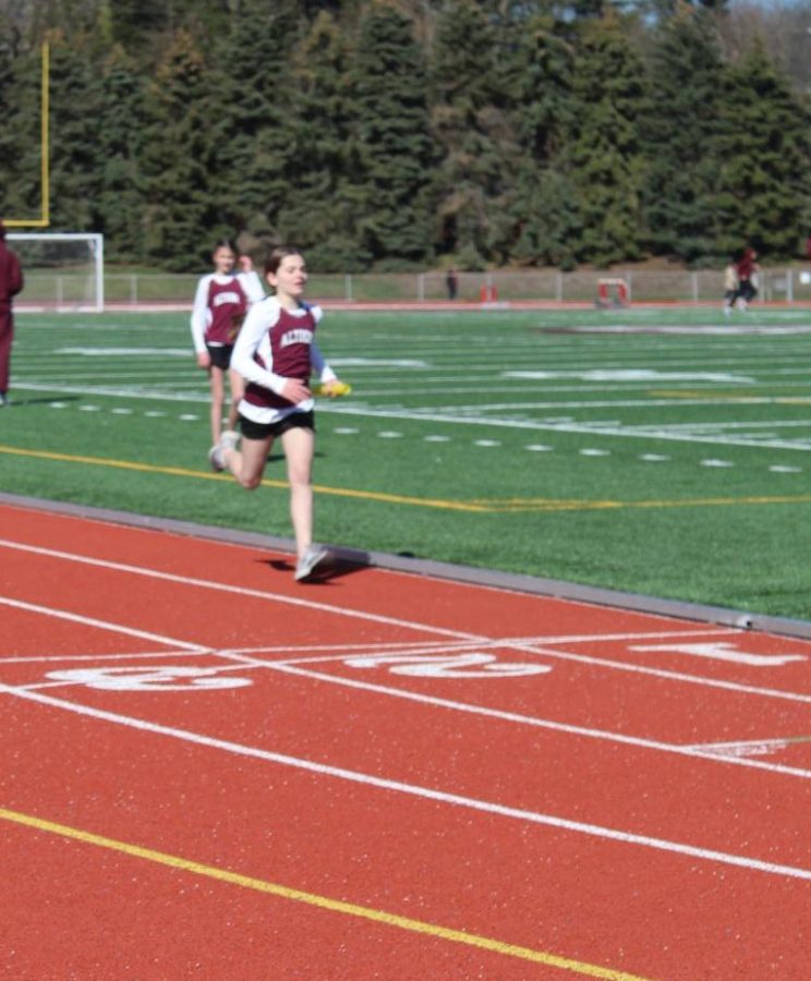 Seventh grader, Gianna Fiore finishes her two laps in the 4 by 800 relay race. Fiore was the fourth runner on her team and finished strong putting her team in second place. 