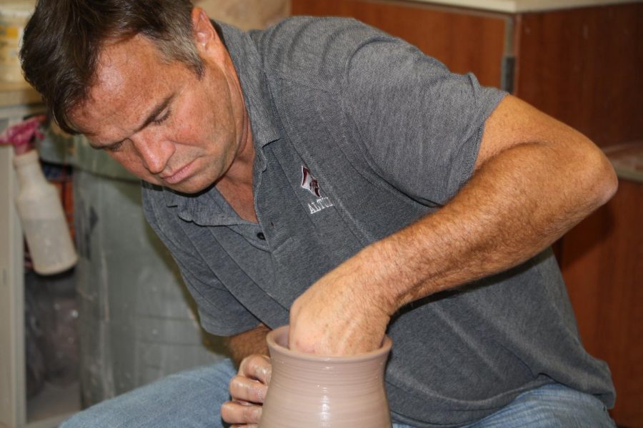  Focus! Eighth grade pottery teacher John King focuses  on creating the vase. This vase had taken King two weeks to form.

