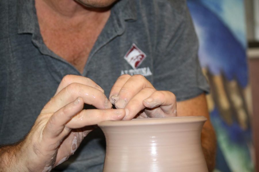 Focus! Eighth grade pottery teacher John King focus on creating the vase. This vase had taken King two weeks to form.