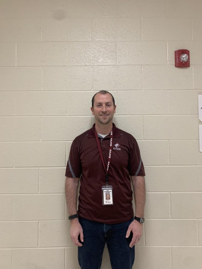 Say Cheese! Sixth grade health teacher Chris Tromm smiles for a picture. He helped his students work on a project moments before.

