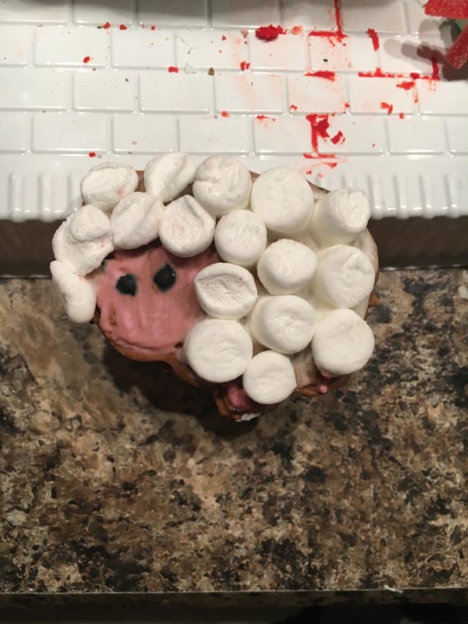 Baa! I got a barn gingerbread house, and it came with a sheep, a cow, a pig and a rooster. I didn’t want to use icing for the wool, so I cut up a bunch of mini marshmallows and used icing to put them on.