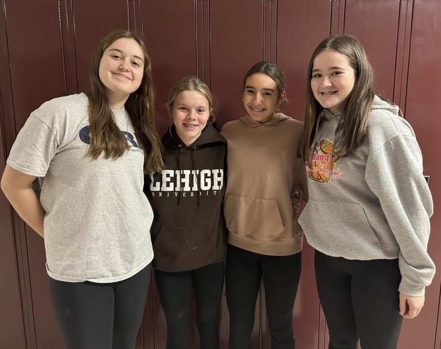 Eighth grade basketball players Ryann Lantzy, Andie Adams, Ajaycia Alexander and Raylin Eyer pose together. The girls will be competing in the game.