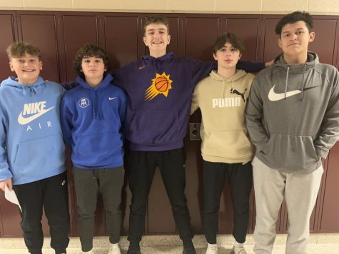 Eighth grade basketball players Justin Pfeffer, Lucas Gority, Eliott McCloskey, Brody Brazile and Judah Curry stand together.