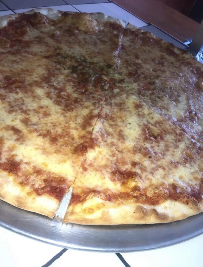 This is what their cheese pizza looks like. There are many different kinds of pizzas they sell like pan pizza, white pizza and round pies.