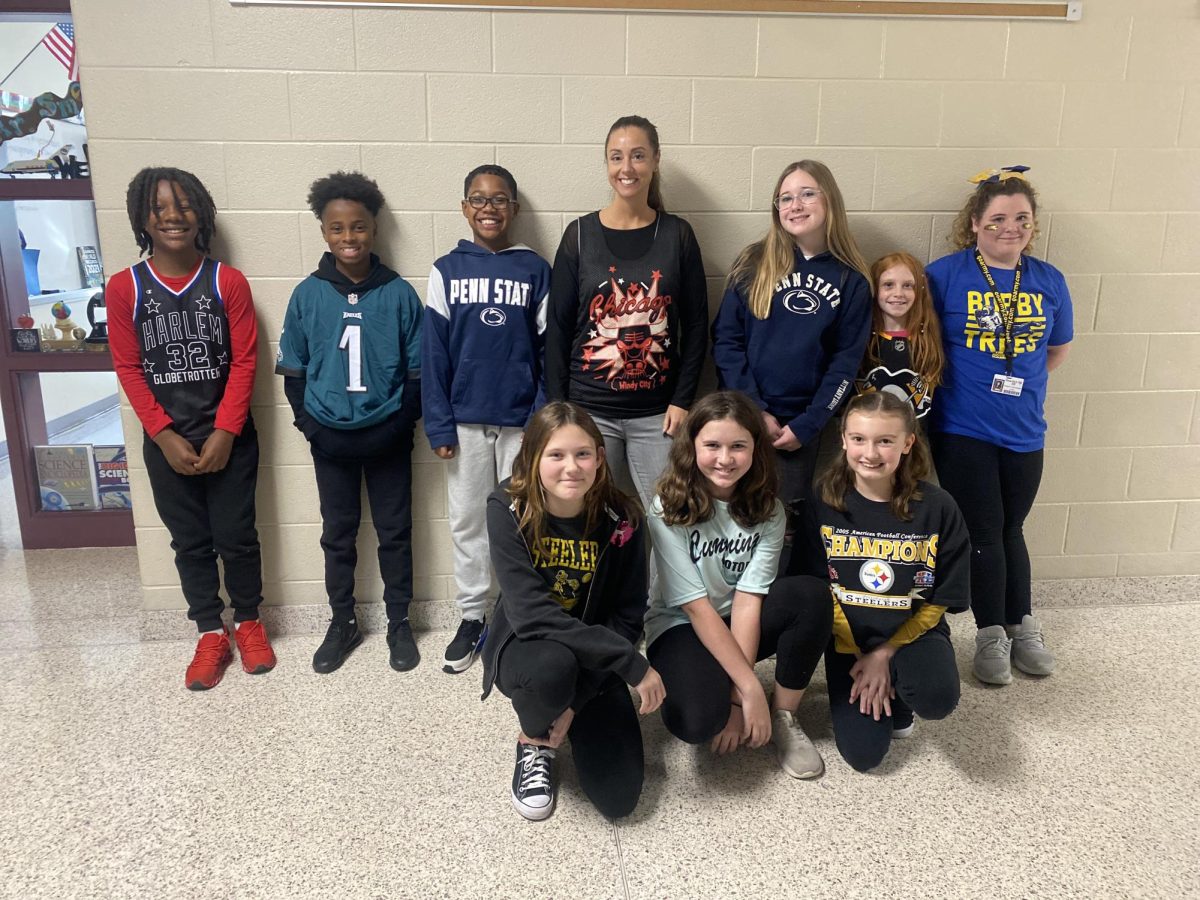 Amy Sinisis sixth grade math class smiles as they wear their sport jerseys. Sinisi was so proud to have drug free students! Students pose from top left to bottom right are
JusTus Walker, Kaidyn Hall, Jamari Samuels, Amy Sinisi, Hayden Over, Rylie Shannon, Bralynn Carmichael
Piper Freet, Aryn Hughes and Kinsley Shannon!

