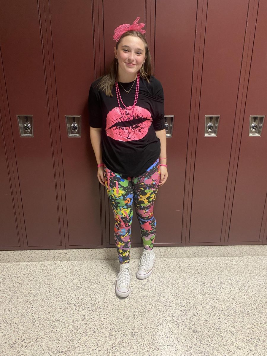 Eighth grader Emma Klein stops and smiles showing off her Decades Day outfit.