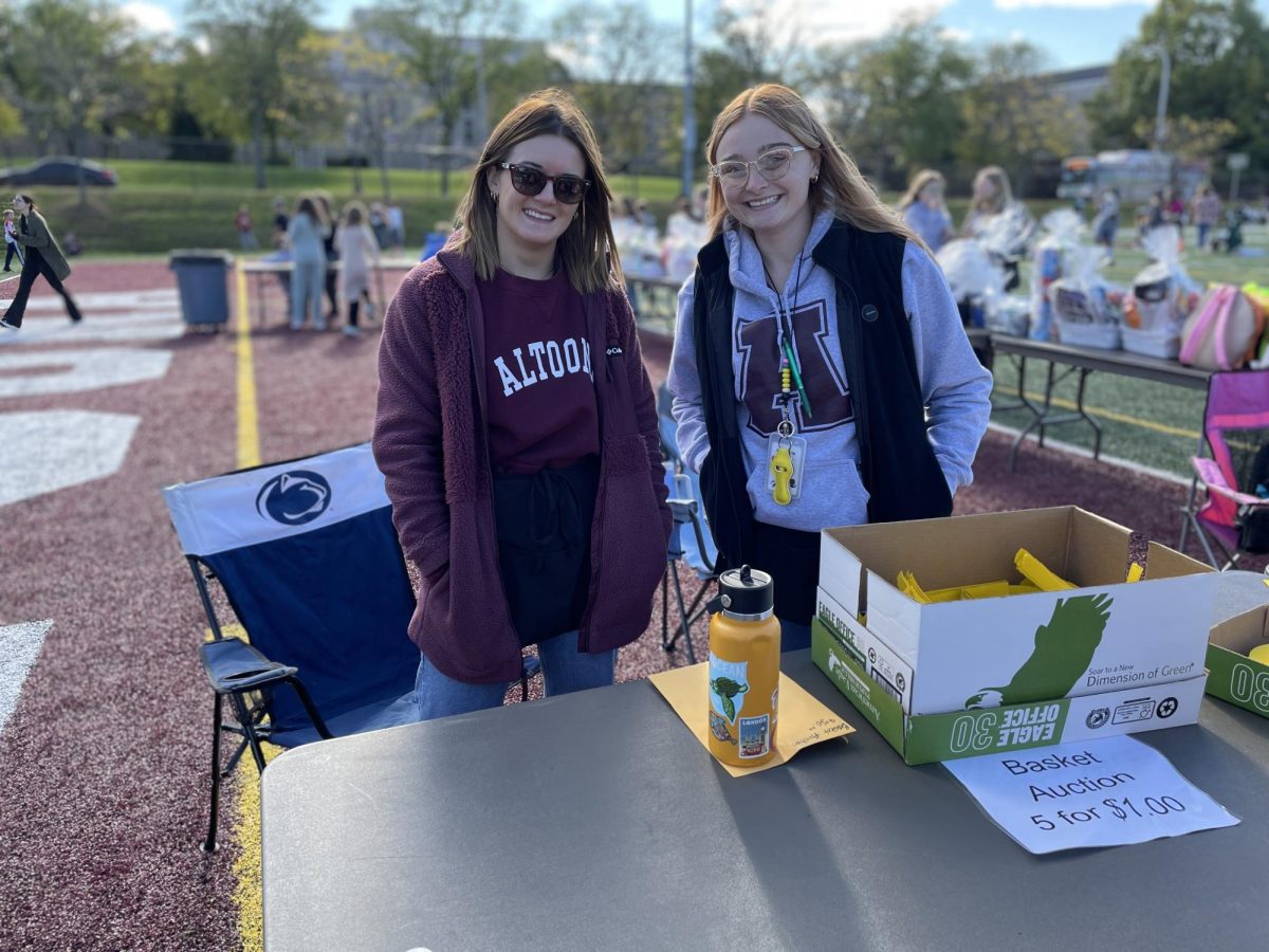 This photo shows eighth grade math teachers Jordan Giordano and  Madelyn Burda working at the basket raffle. They were very busy throughout the day.