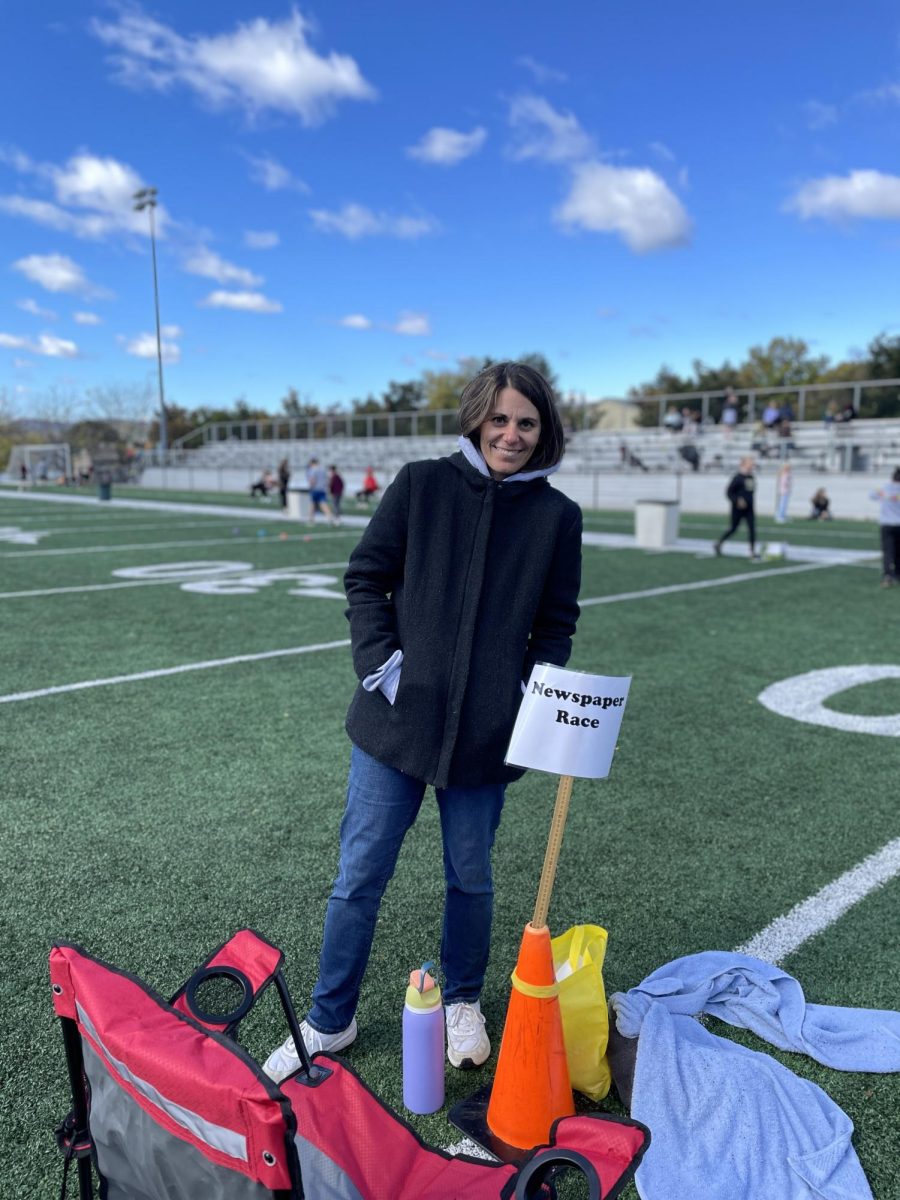 Sixth grade math teacher Melissa Krott was a great help at Harvest Day! She is shown here working at the newspaper race. The winner of the race was rewarded with a piece of candy, making a popular spot for friends to challenge each other.