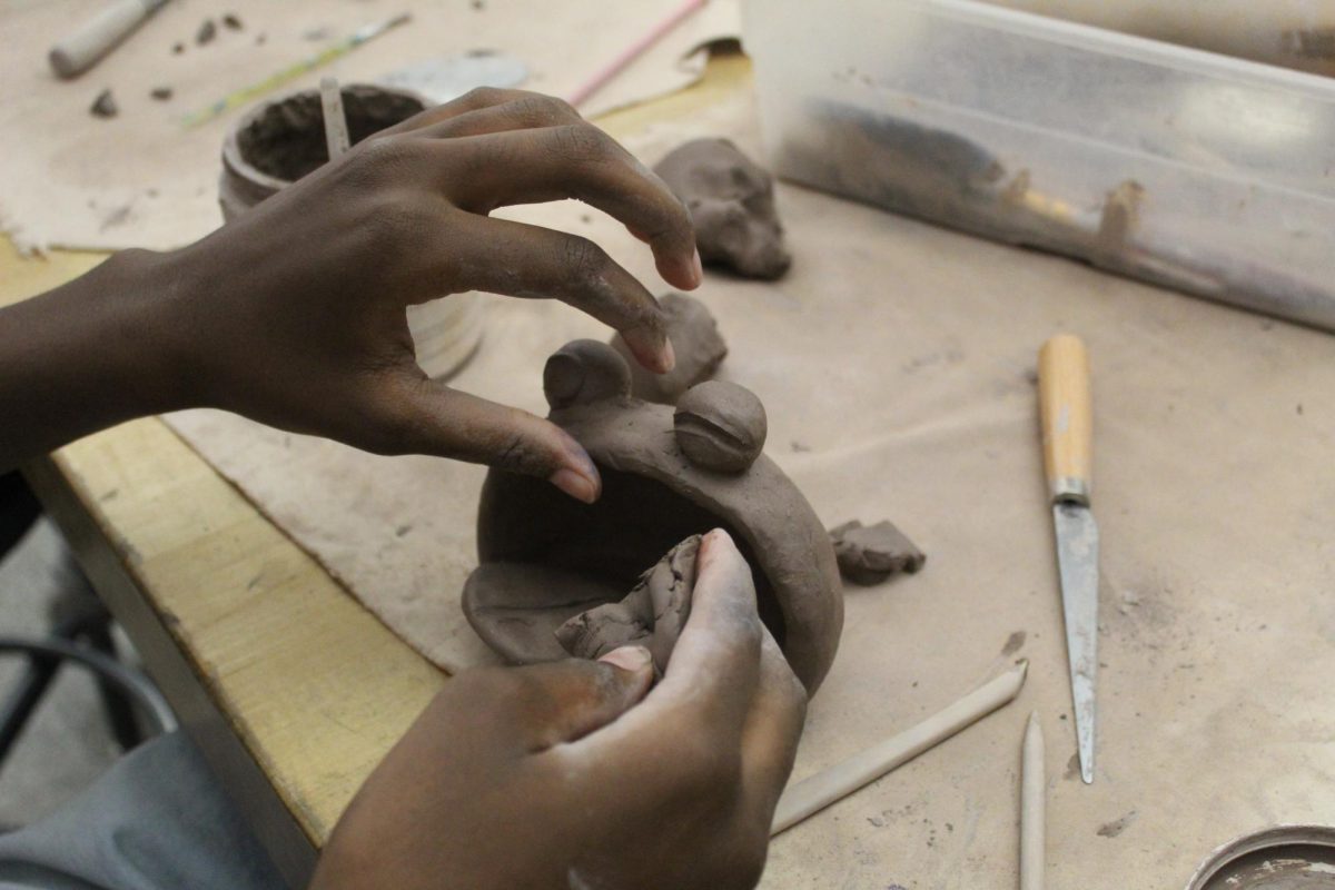 Finish that pot! Eight grader Gilmore  is finishing up on her Cookie Monster. She just needs to blend her edges together then she is done.