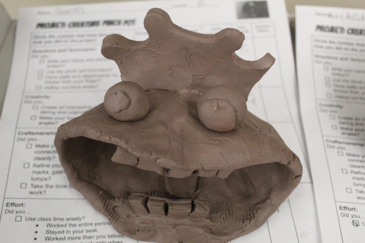 Say, cheese! Eight grader Ka'Mya Carter just finished her monster pot, and  it is so scary.  She put a lot of hard effort into this pot.