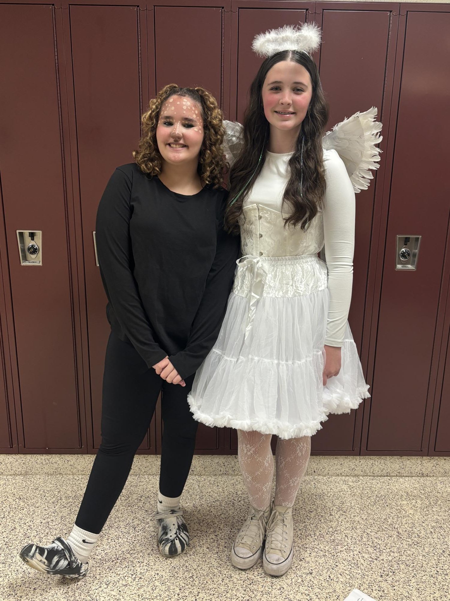 Say cheese! Eighth graders Hailey Hamilton and Charolette White dress up in their Halloween costumes at school. Hamilton decorates her face in beautiful deer makeup with White staying true to her name and dressing in an all white angel costume.