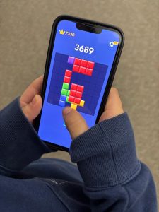 Block by block! Eighth grader Alonna Pfahler places blocks together while playing Block Blast on her phone! "I love playing the game whenever I can," said Pfahler.