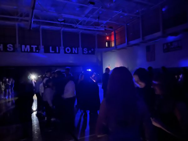 Lights out! The lights are turned off and the DJ starts to blast music. Eighth grader Aubrie Mclellan says, "The music was really good. It was fire!"