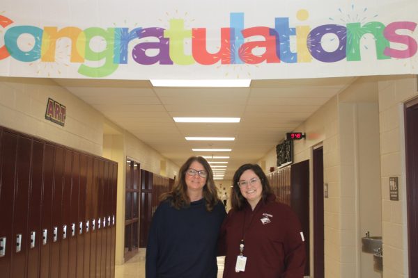 Congratulations! Eighth counselors Bridget Stroh and Sydney Koehle pose together under the decorations to celebrate Koehle's first day back at school.