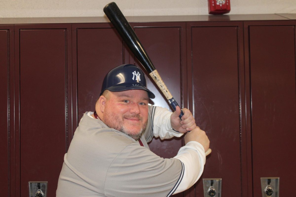 Home run! Eight grade math teacher Jason Hatch steps up into the box to swing. Hatch is a fan of the New York Yankees. 